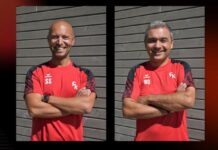 FC Küssnacht setzt weiter auf Trainerduo Sorrentino/Ordonez Two men in red sports shirts with black sleeves stand side by side, arms crossed, smiling in front of a gray wooden wall; initials 'SS' and 'RO' appear on their chests.