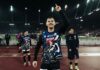 FCL: Adrian Bajrami wechselt zum SC Braga Athlete on a track field raises a finger in victory, lights glow in the rainy stadium behind him.