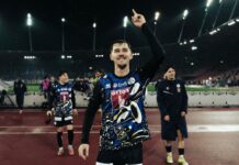 FCL: Adrian Bajrami wechselt zum SC Braga Athlete on a track field raises a finger in victory, lights glow in the rainy stadium behind him.