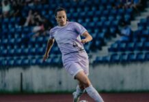 Cristina Carp verlässt den FC Luzern Female soccer player in a light purple uniform dribbles a ball on a grass field, with blue stadium seats in the background.