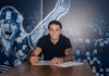 FCL: Lucas Manuel Silva Ferreira verlängert vorzeitig Young man smiles while signing a document at a table, blue mural backdrop behind him