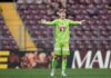 Severin Ottiger und Pascal Loretz verlassen den FC Luzern Soccer goalkeeper in neon green kit stands with arms outstretched on the pitch during a match.