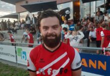 Buttisholz siegt verdient gegen Wauwil-Egolzwil Bearded man in a red and white diagonal-striped sports jersey stands in front of spectators at an outdoor stadium.