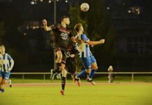 Ibach fordert unbequeme Tessiner Two soccer players leap to head the ball during a night match on a grass field, under stadium lights.