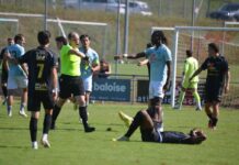 Buochs schlägt Schötz im Derby eiskalt Soccer match scene with a player on the ground as others stand around and a referee points a call toward the field.